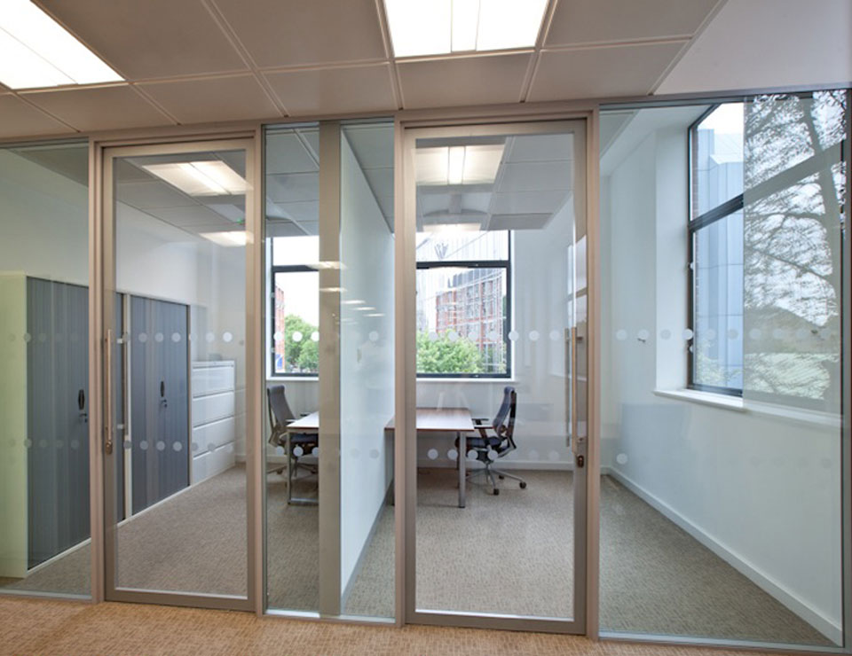 Floor to ceiling glass partitions paired with a glass door