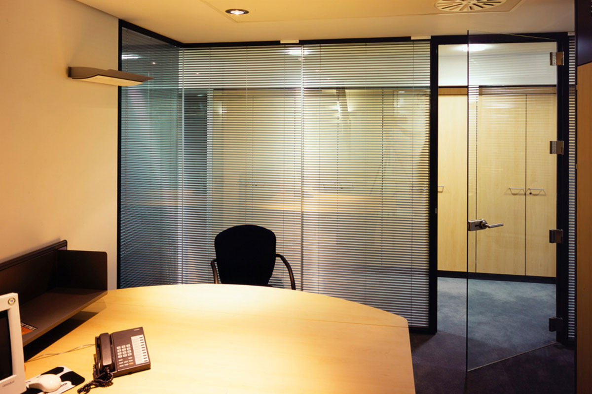 Floor-to-ceiling glass walls with integrated blinds
